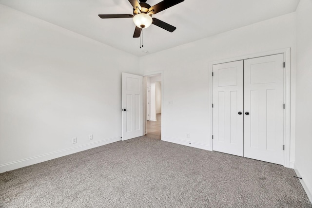 unfurnished bedroom featuring carpet, a closet, and ceiling fan