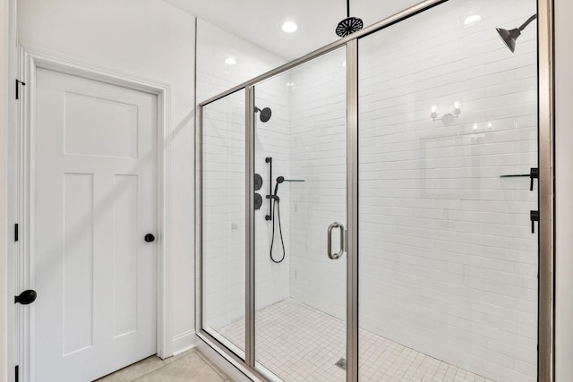 bathroom with tile patterned floors and an enclosed shower