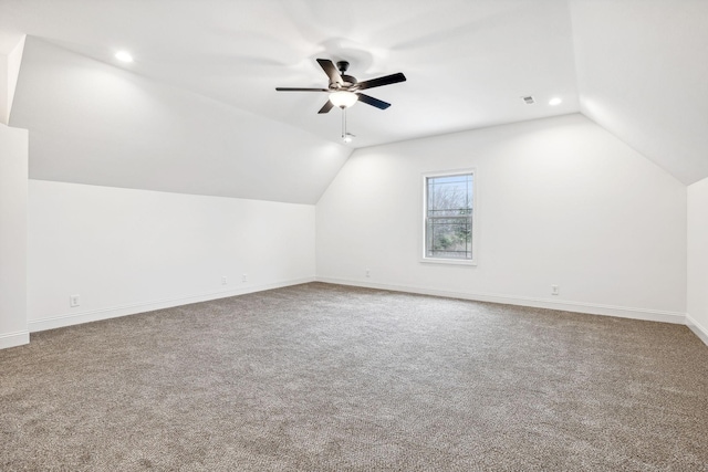 additional living space featuring carpet, vaulted ceiling, and ceiling fan