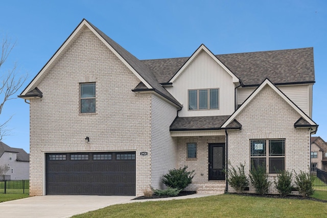 view of front of home featuring a garage and a front lawn