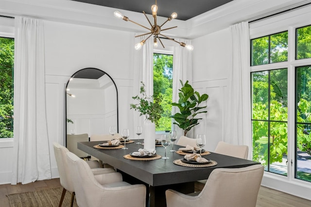 dining room featuring hardwood / wood-style floors and a notable chandelier