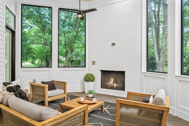 sunroom / solarium with plenty of natural light and a brick fireplace