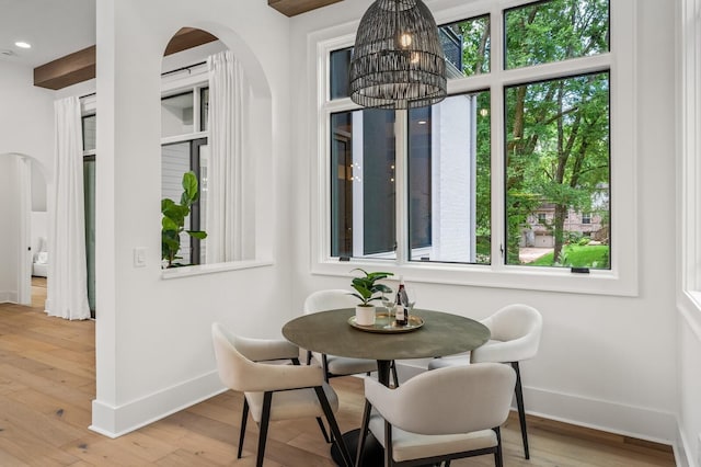 dining space featuring an inviting chandelier and light hardwood / wood-style flooring