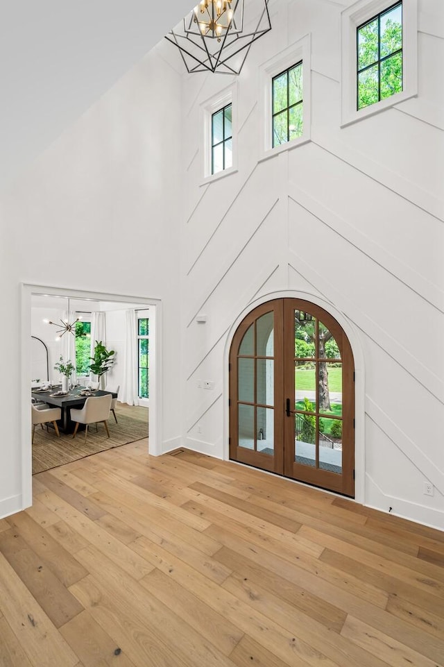 entrance foyer featuring a chandelier, hardwood / wood-style flooring, and a wealth of natural light