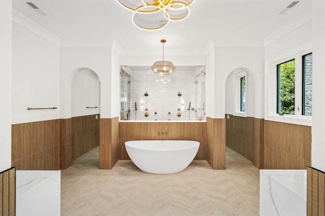 bathroom with separate shower and tub, an inviting chandelier, and crown molding