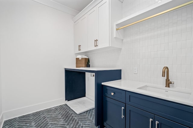 interior space featuring decorative backsplash, crown molding, and sink