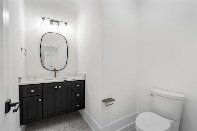 bathroom featuring tile patterned flooring, vanity, and toilet