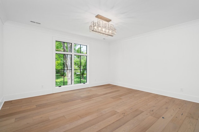 spare room featuring light hardwood / wood-style flooring and ornamental molding