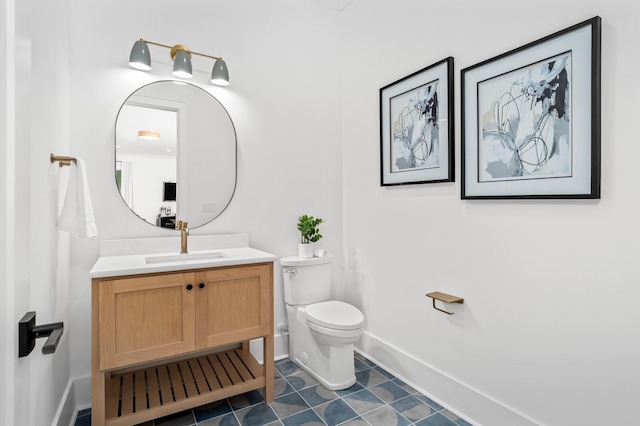 bathroom featuring tile patterned floors, vanity, and toilet