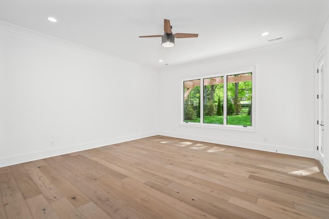 spare room featuring light hardwood / wood-style flooring, ceiling fan, and crown molding