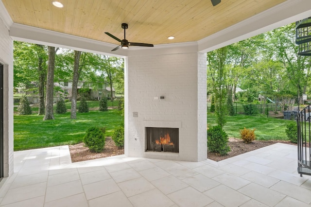 view of patio / terrace with an outdoor brick fireplace and ceiling fan