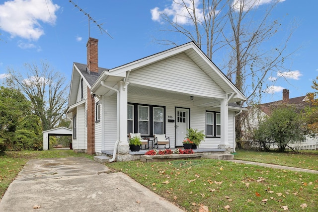 bungalow-style house with covered porch and a front yard