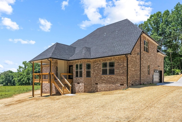 back of house with covered porch and a garage