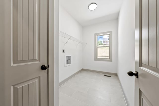 washroom featuring electric dryer hookup, hookup for a washing machine, and light tile patterned floors