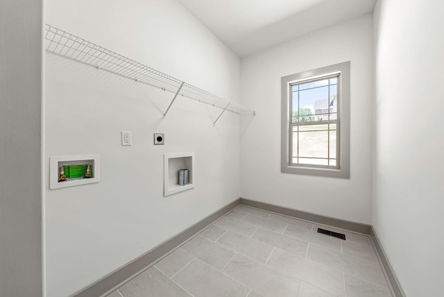 clothes washing area featuring light tile patterned floors, washer hookup, and hookup for an electric dryer