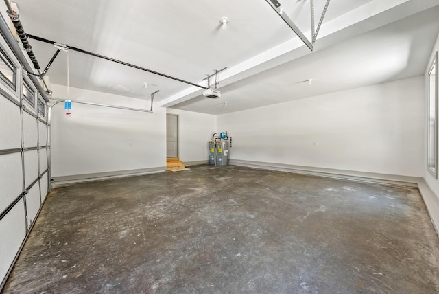 garage featuring a garage door opener and water heater