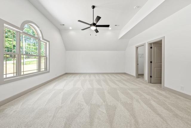 additional living space featuring ceiling fan, light carpet, and vaulted ceiling