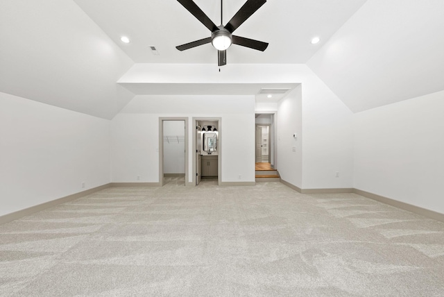 additional living space featuring ceiling fan, light colored carpet, and vaulted ceiling