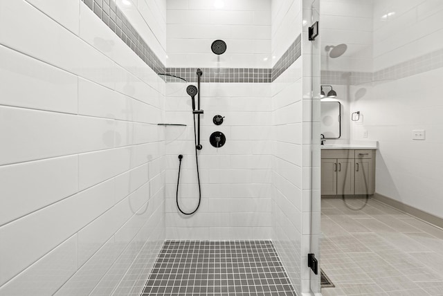 bathroom with vanity and tiled shower