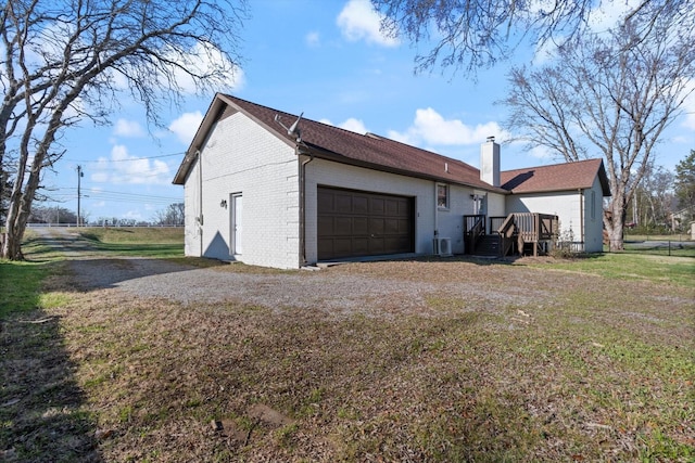 view of home's exterior with a garage and a yard