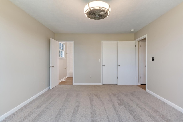 unfurnished bedroom featuring light carpet