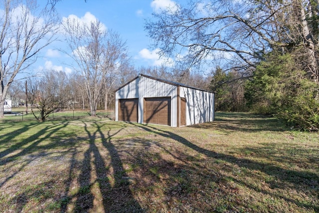 view of outbuilding featuring a garage and a yard