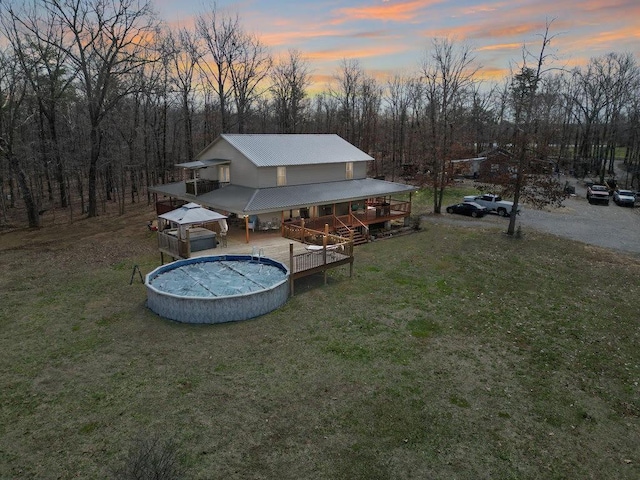 exterior space featuring a swimming pool side deck and a yard