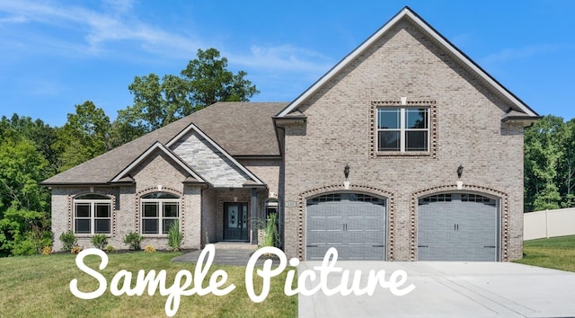 view of front of property with a garage and a front yard