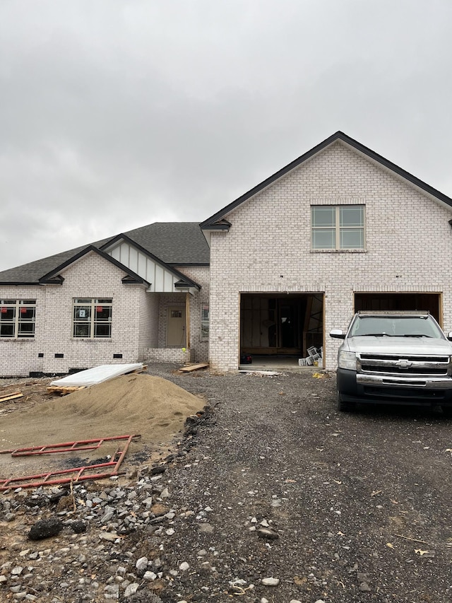 rear view of property with a garage