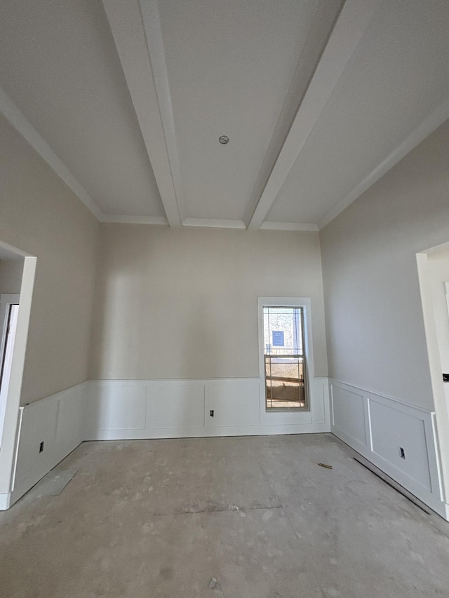 empty room featuring beamed ceiling