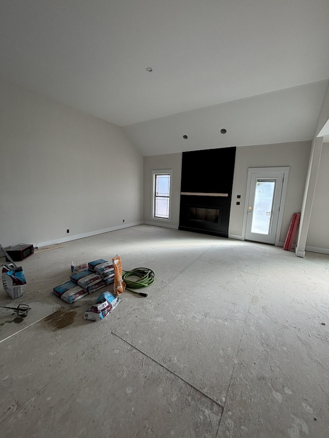 unfurnished living room with lofted ceiling