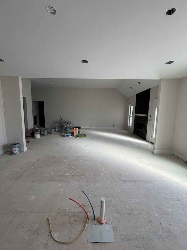 unfurnished living room with vaulted ceiling