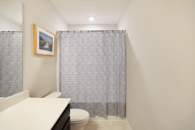 bathroom featuring tile patterned flooring, vanity, and toilet