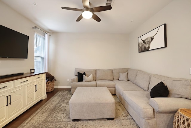 living room featuring wood-type flooring and ceiling fan