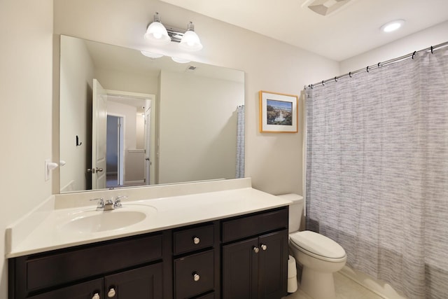 bathroom with tile patterned floors, curtained shower, vanity, and toilet