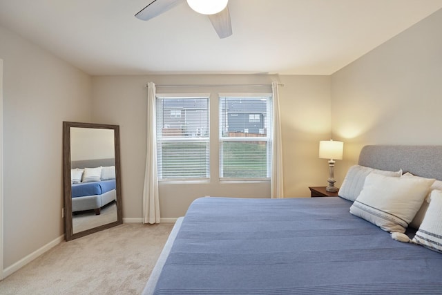 bedroom featuring ceiling fan and light carpet