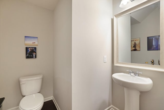 bathroom featuring toilet and sink