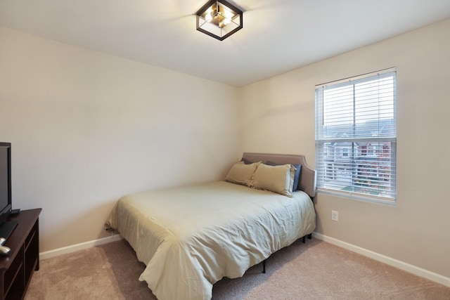 bedroom with light colored carpet