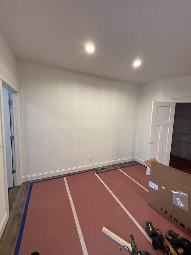 interior space featuring recessed lighting and dark wood-style floors