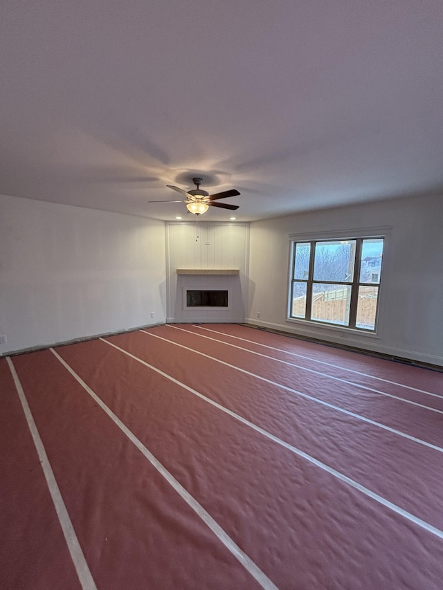 unfurnished living room featuring ceiling fan