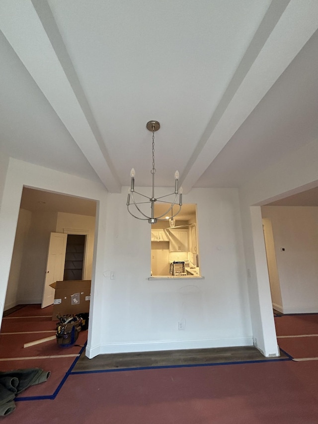 dining area with a chandelier, beamed ceiling, and baseboards