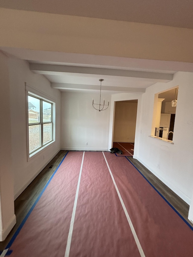 interior space with beamed ceiling, baseboards, and a chandelier