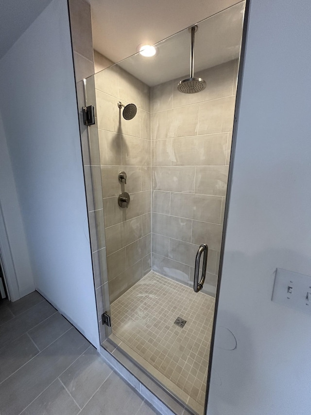 bathroom with tile patterned floors and a stall shower