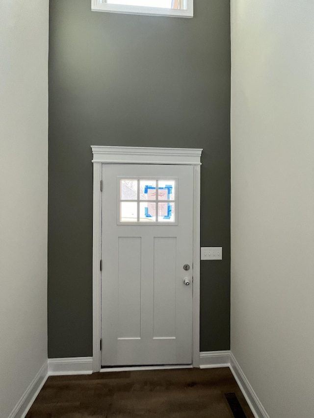 entryway with visible vents, baseboards, and dark wood finished floors