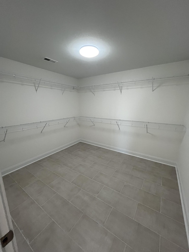 walk in closet with visible vents