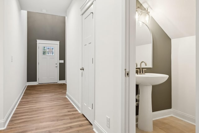 bathroom with baseboards and wood finished floors