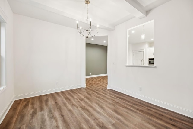 unfurnished dining area featuring a chandelier, wood finished floors, baseboards, beamed ceiling, and recessed lighting