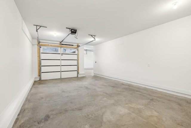 garage with baseboards and a garage door opener