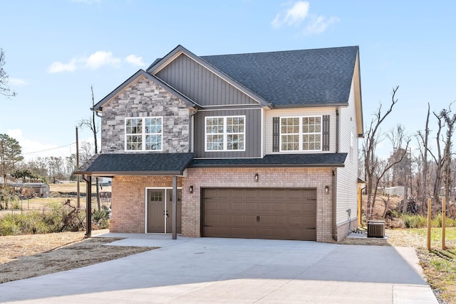 view of front of property with a garage and cooling unit