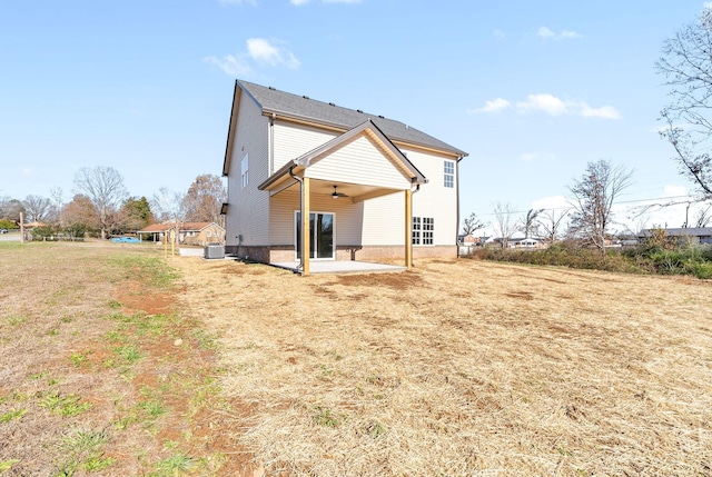 back of property with a lawn, ceiling fan, a patio, and central AC